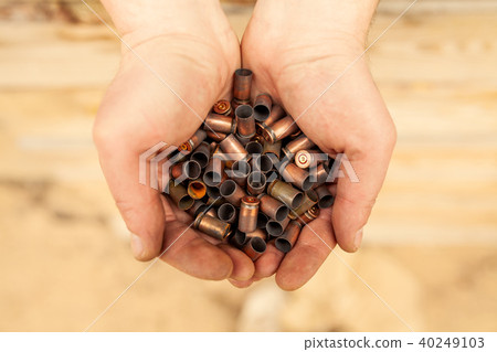 Cases of cartridges in the hands 40249103