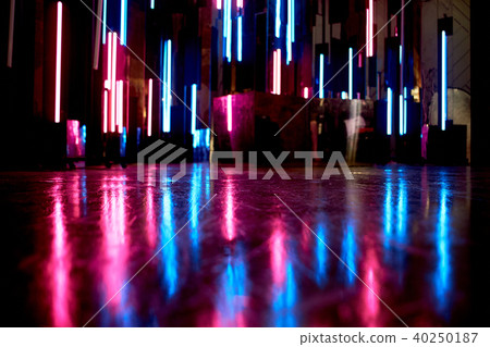 The reflection of blue and pink light at the surfaces. The atmosphere of the club, the parties 40250187