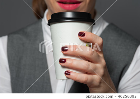 Closeup of office worker holding cup with coffee 40256392