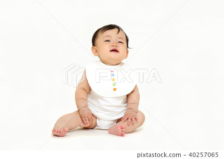 Little baby girl sitting alone in front of white background Little baby girl sitting alone in front of white background 40257065