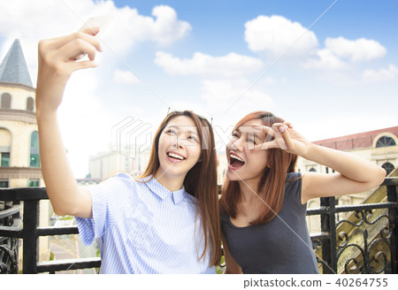 two happy girls taking selfie and travel concept 40264755