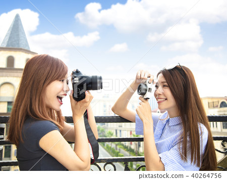two happy girls holding camera and travel concept 40264756
