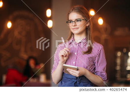 Portrait of a beautiful friendly waitress in glasses with notepapers and pen ready to take your Portrait of a beautiful friendly waitress in glasses with notepapers and pen ready to take your 40265474