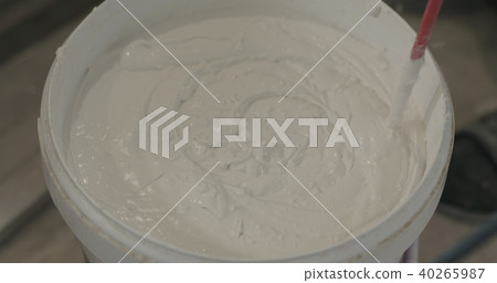 stirring putty in the bucket 40265987