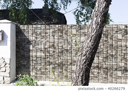 Fence made of rolled metal. Fence made of rolled metal. 40266279