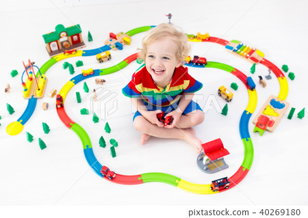 Child with toy train. Kids wooden railway. Child with toy train. Kids wooden railway. 40269180