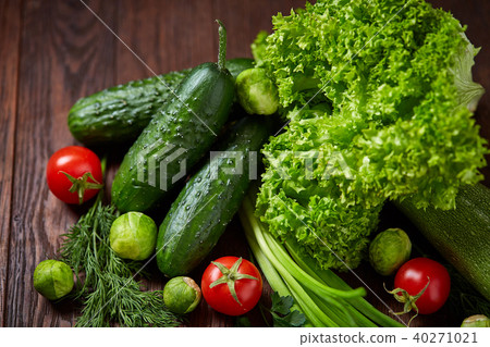 Fresh vegetables composition over wooden background, close-up, flat lay. 40271021