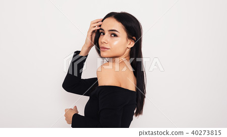 Side view of young model wearing black dress Side view of young model wearing black dress 40273815
