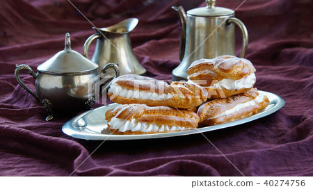 eclairs, filled with whipped cream 40274756