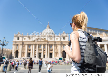 Woman on St. Peter's Square in Vatican in front of St. Peter's Basilica. 40276495