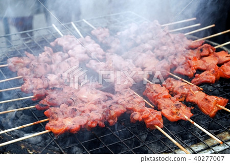 Chicken barbecue grilling  on smoky charcoal stove 40277007