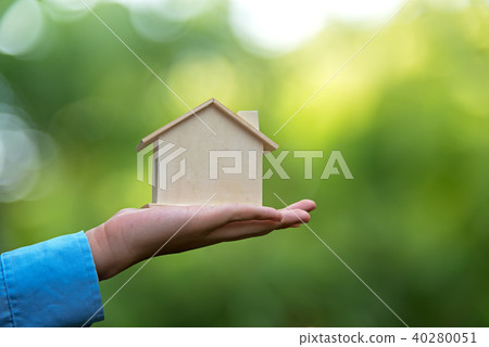 Man holding house representing home Man holding house representing home 40280051