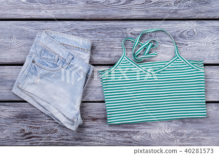 Folded denim jeans and blouse. Folded denim jeans and blouse. 40281573