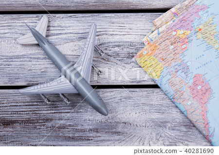Miniature toy airplane and map. Miniature toy airplane and map. 40281690