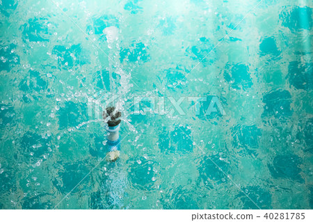 water splash from sprinkle in pool 40281785