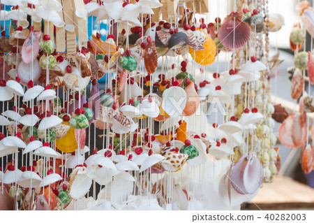 Hanging decor by sea shells at street shops. 40282003
