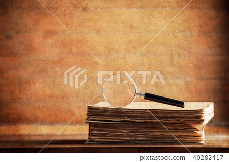 little magnifier and book on a table little magnifier and book on a table 40282417