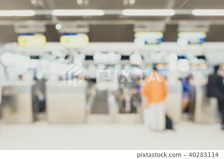 BlurredTraveler with baggage check in counter 40283114