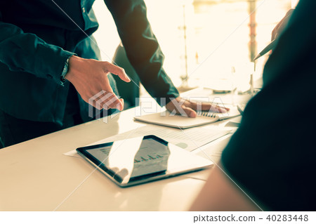 Manager pointing data in tablet and employee 40283448
