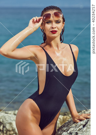 slim attractive woman posing in blue waters of Adriatic sea beac slim attractive woman posing in blue waters of Adriatic sea beac 40284257