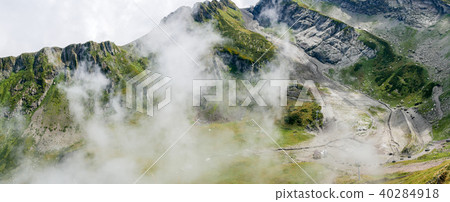Photo of mountain slopes with vegetation and cloudy sky Photo of mountain slopes with vegetation and cloudy sky 40284918