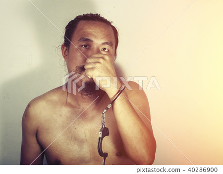 portrait of a man prisoner with handcuff portrait of a man prisoner with handcuff 40286900