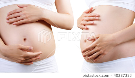 Young pregnant woman caress belly. Young pregnant woman caress belly. 40287353