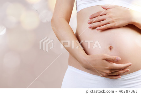Young pregnant woman caress belly. Maternity concept. Young pregnant woman caress belly. Maternity concept. 40287363