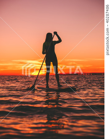 Woman stand up paddle boarding 40287486