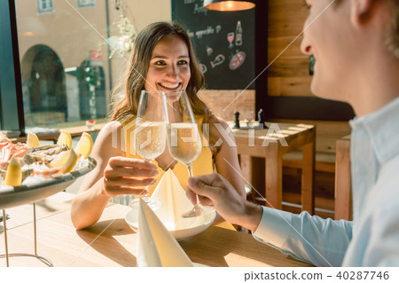 Beautiful woman toasting during a romantic dinner with her partner Beautiful woman toasting during a romantic dinner with her partner 40287746