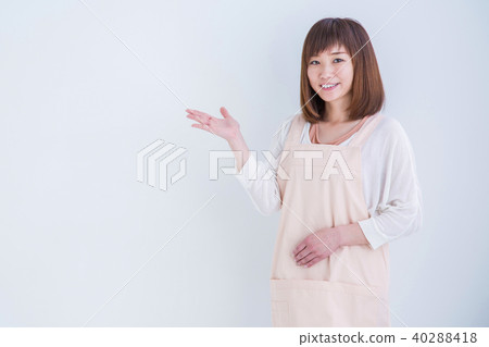 A lady with an apron in order to show off 40288418