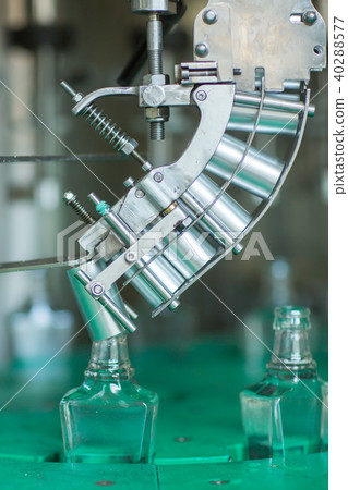 Bottles with a drink closed with a screw cap. Factory for the production of alcoholic beverages 40288577