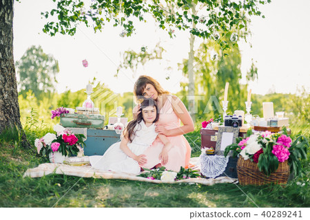 happy beautiful mother and daughter resting on a blanket in nature on a summer happy beautiful mother and daughter resting on a blanket in nature on a summer 40289241