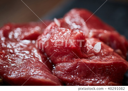 Composition of raw beefsteak on slate board with vegetables and seasoning, selective focus, close-up 40291082