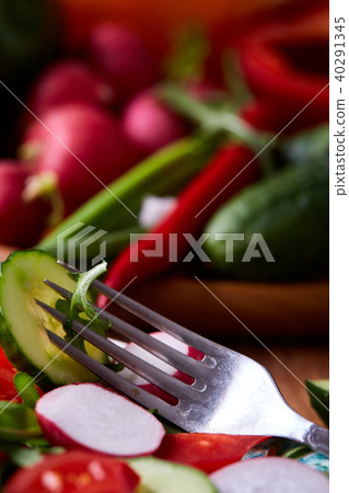 Creative fresh vegetable salad with ruccola, cucumber, tomatoes and raddish on white plate Creative fresh vegetable salad with ruccola, cucumber, tomatoes and raddish on white plate 40291345