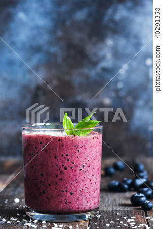 Blueberry smoothie decorated with basil leaf 40291358