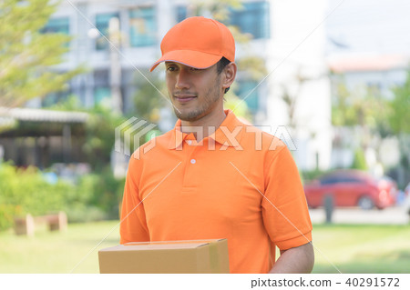 Delivery man in orange is handing packages 40291572