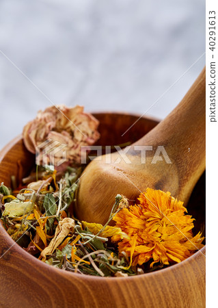 Spa still life with flowers in wooden bowl on light textured background, top view, close-up Spa still life with flowers in wooden bowl on light textured background, top view, close-up 40291613