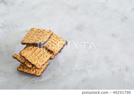 Square biscuits arranged in pattern on light textured background, close-up, shallow depth of field Square biscuits arranged in pattern on light textured background, close-up, shallow depth of field 40291790
