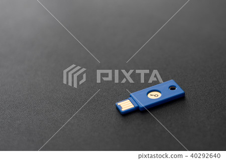 Security system concept. Key-shaped USB drive on dark background. Technology and data security theme Security system concept. Key-shaped USB drive on dark background. Technology and data security theme 40292640