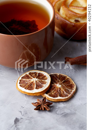 Homemade rose bread, cup of tea, dried citrus and spicies on white textured background, close-up 40294152