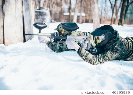 Two paintball players lies on the snow 40295989