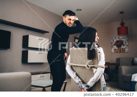 Robber maniac in black clothes beats female victim Robber maniac in black clothes beats female victim 40296417