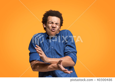 Let me think. Doubtful pensive man with thoughtful expression making choice against orange Let me think. Doubtful pensive man with thoughtful expression making choice against orange 40300486