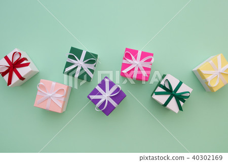 Gift boxes with ribbons on green pastel background 40302169