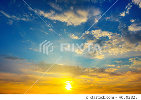 Cloudy sky and bright sun rise over the horizon. Cloudy sky and bright sun rise over the horizon. 40302825
