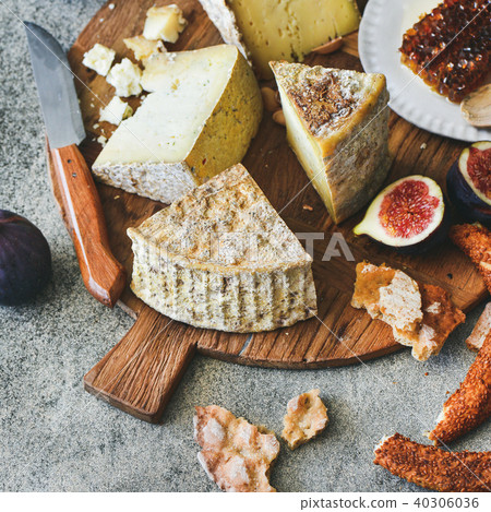 Cheese assortment, figs, honey, fresh bread and nuts, square crop Cheese assortment, figs, honey, fresh bread and nuts, square crop 40306036