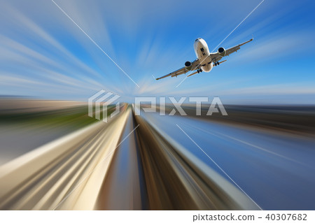 Airliner over highway on blurred background 40307682