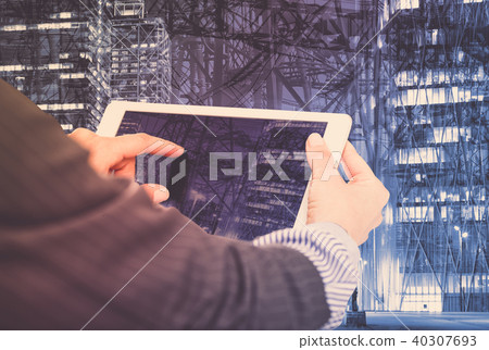 Female hands with tablet on industrial background 40307693