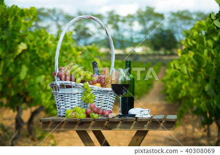 Red wine with cheese, bread in basket and grapes Red wine with cheese, bread in basket and grapes 40308069